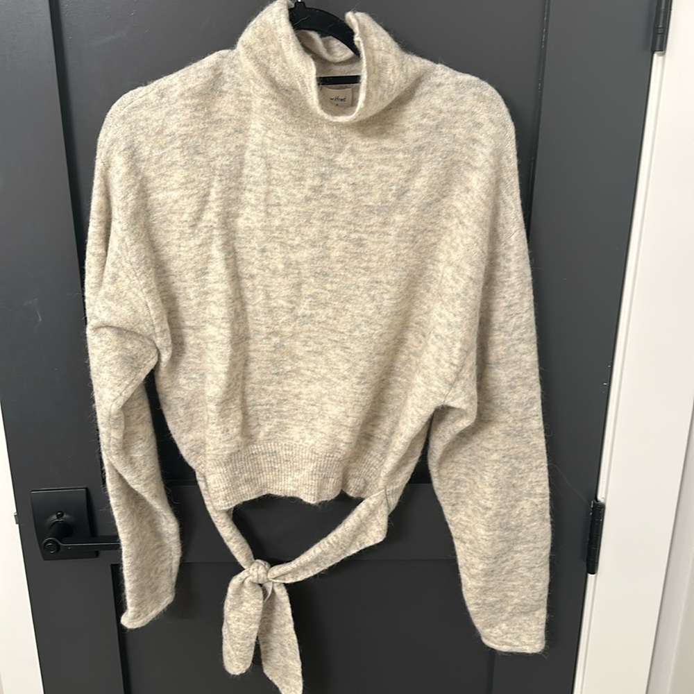 Ivory turtleneck sweater with tie